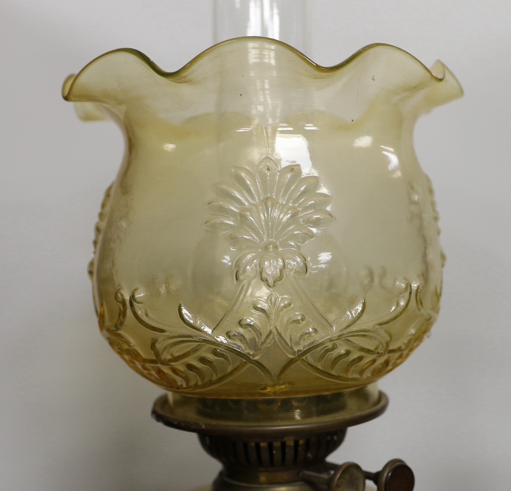 An Edwardian brass desk lamp with glass shade and a Victorian brass columned oil lamp with shade, oil lamp 65cms high
